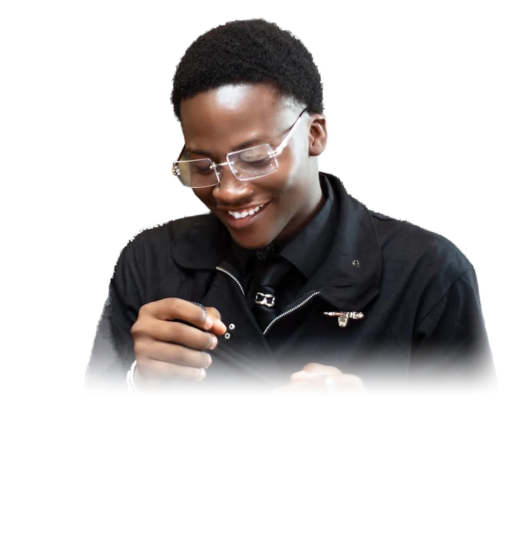 Oyekola Obajuwon, called Juwon, smiling in a black jacket and rimless glasses. Photo by Hotman Visuals.